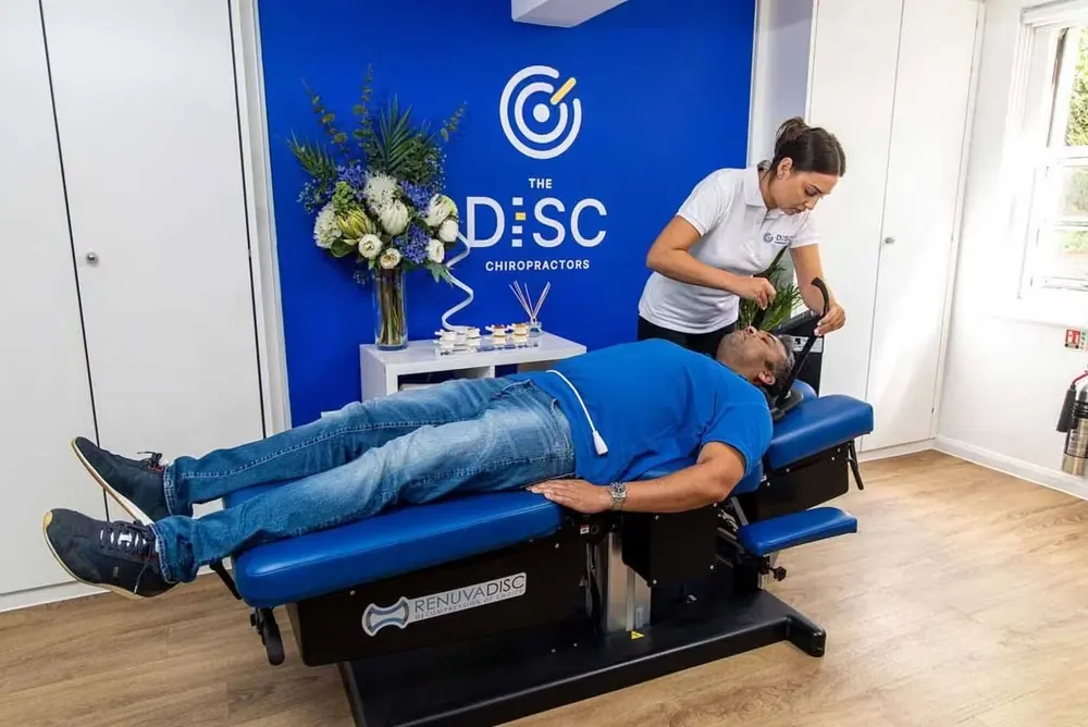 A patient on a RenuvaDisc spinal decompression table at The DISC Chiropractors
