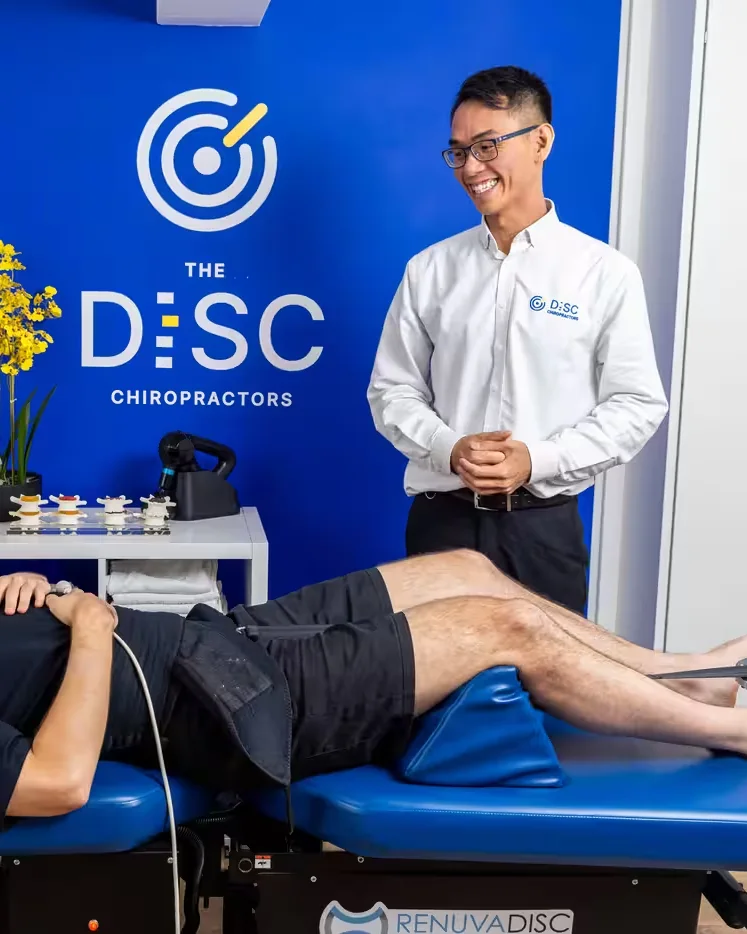 Dr Ka Kin Lee with a patient on the RenuvaDisc spinal decompression table